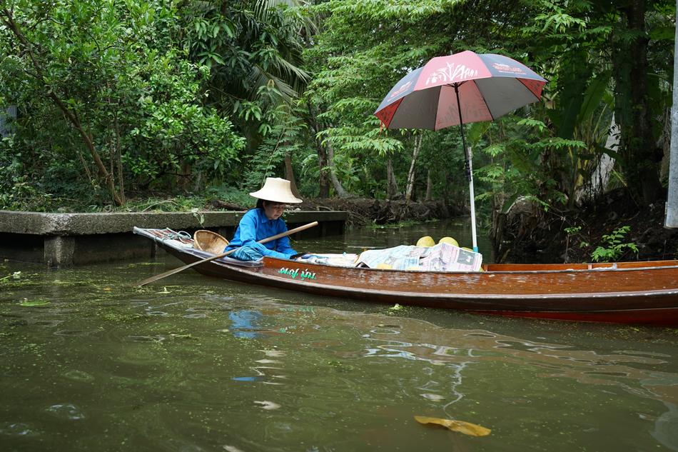 a woman in a blue shirt in a boat
