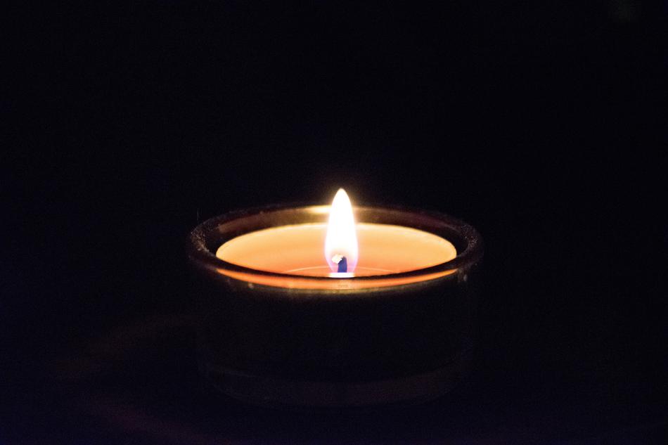 a burning candle in the night