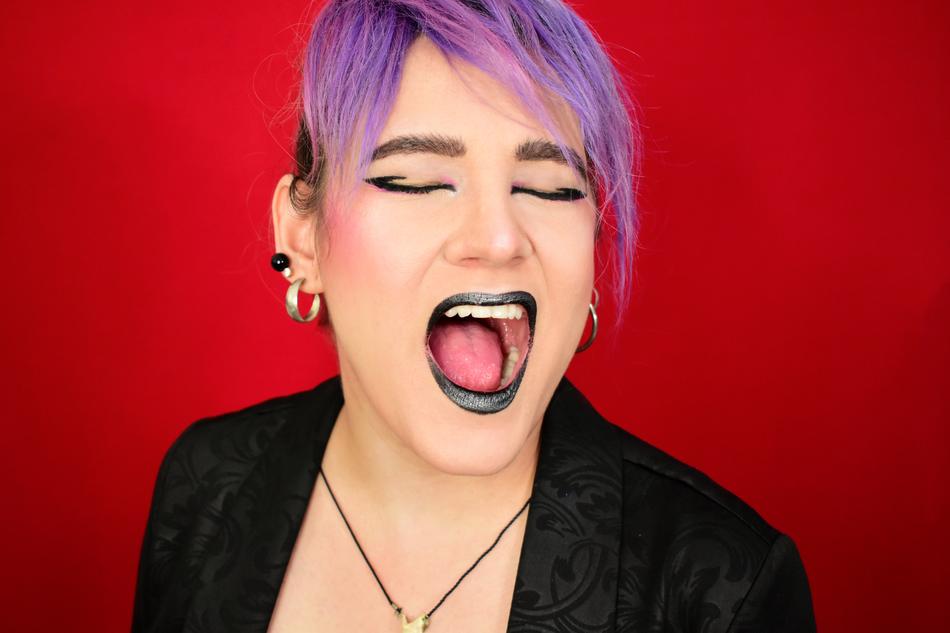 a girl screaming with purple hair.