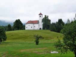 a beautiful church with a green meadow