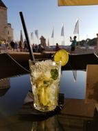 glass with a cold drink and a lime