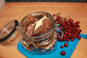 Dried mushrooms in a jar with berries
