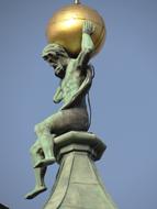 Sculpture of a man holding golden ball