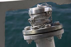 Close-up of the shiny metal water connection of the boat