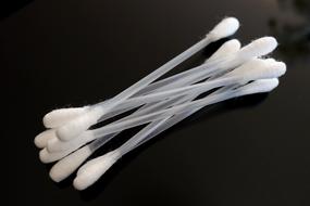 Cotton swabs with transparent sticks at black background