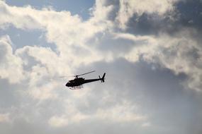 helicopter flight in gray cloudy sky