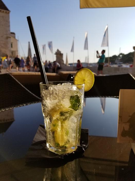 glass with a cold drink and a lime