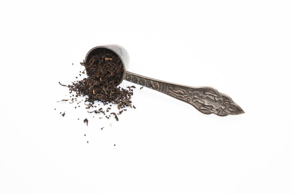 scattered black tea from a spoon