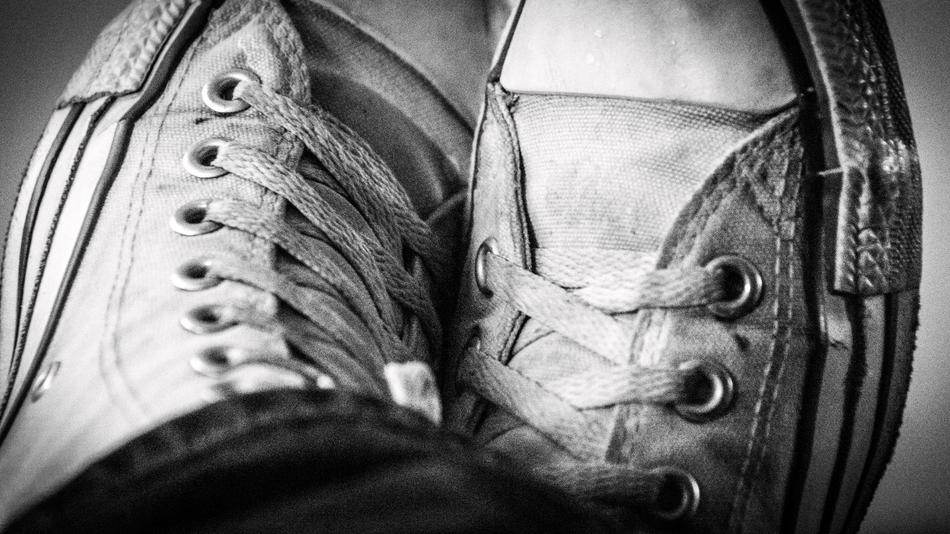 white lace-up sneakers are dirty.