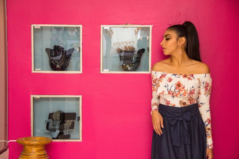 a girl in a skirt and blouse in the background of photos