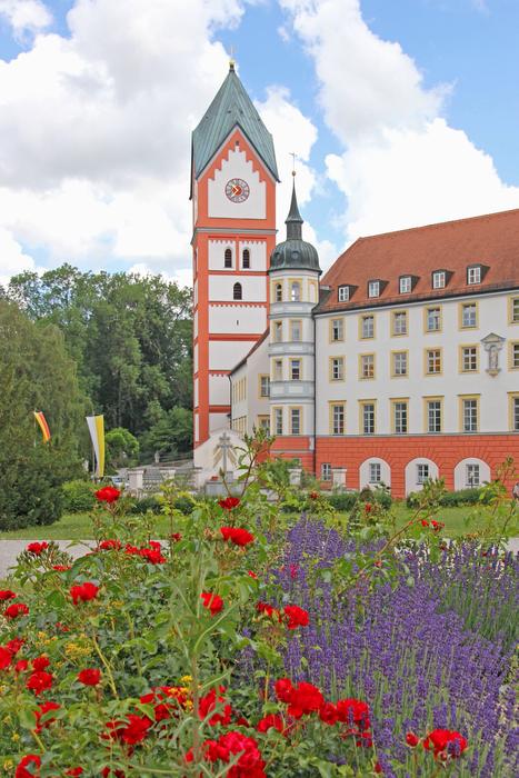 a large palace with flowers in a meadow