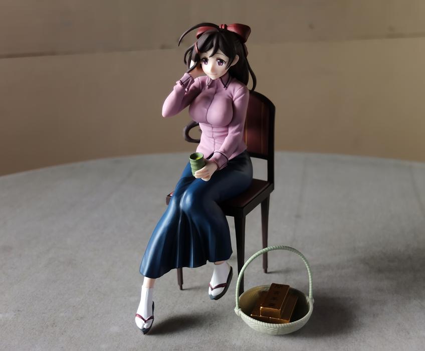 Japanese figurine of a girl on a chair