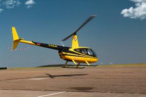 yellow helicopter over the runway