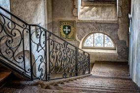 stairs descending to the window with an arch