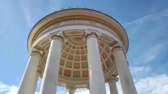 white columns with a roof on a blue background