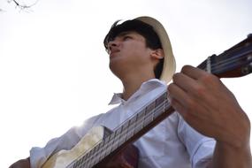 Musician, low angle portrait of young man with guitar