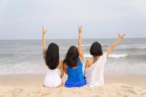 girls in dresses on the sand