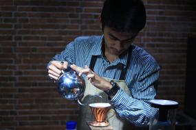 male barista makes coffee