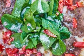 green basil on pizza