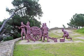 sculpture of people with a wheel