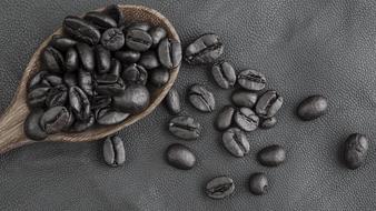 black coffee in a wooden spoon