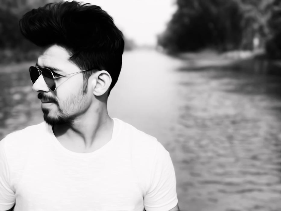 black and white, attractive man in sunglasses on the background of the river