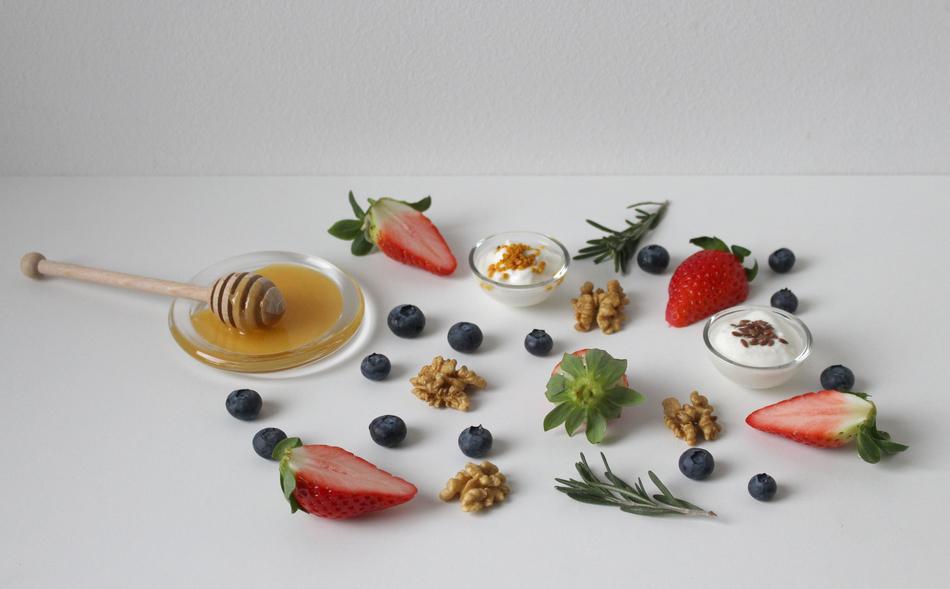 honey and fruit on a white table