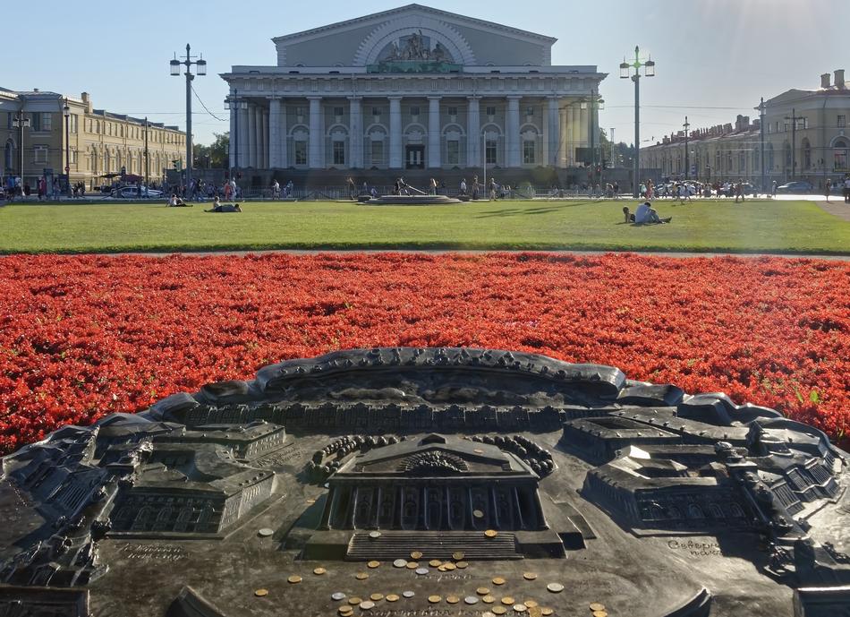 white building near the red flowers