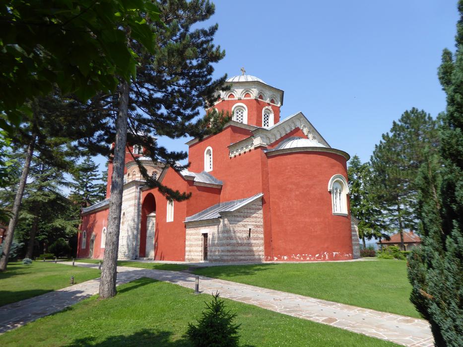 Red monastery near the trees