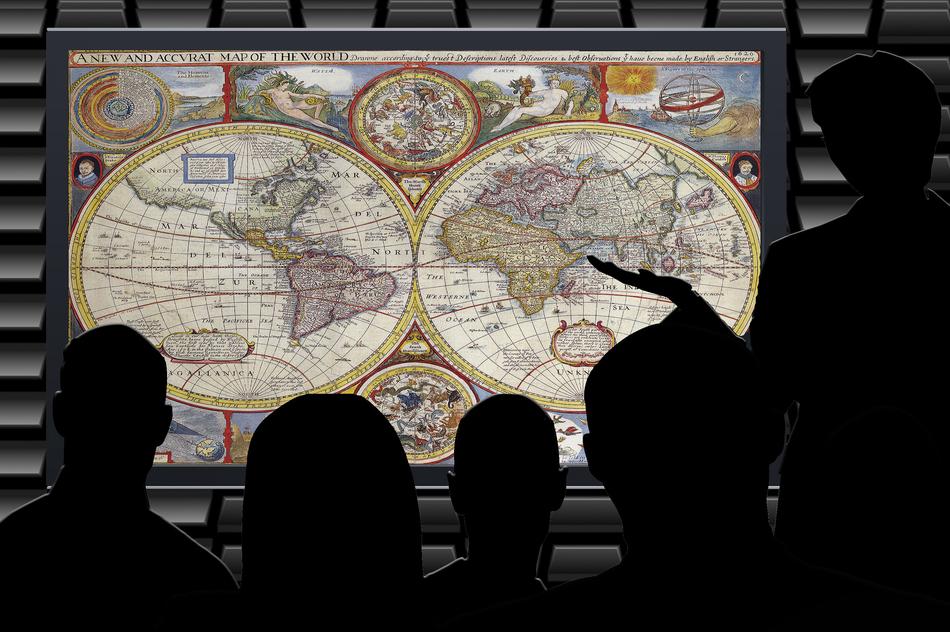 Silhouettes of the people, near the colorful map on the lecture