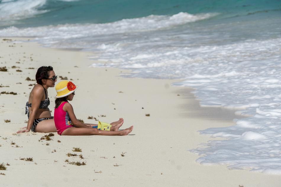 mom and child on sand beach