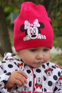 photo of a girl in a pink hat with a picture of Mickey Mouse