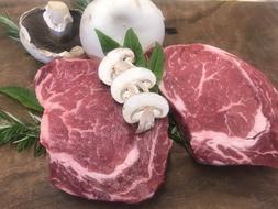 raw piece of meat with porcini mushrooms