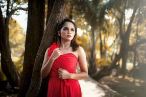 portrait of red dressed girl in park