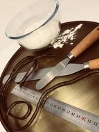 flour in a plate and tools on the table