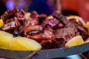 Fried juicy meat with potatoes