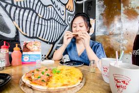 girl eating delicious pizza