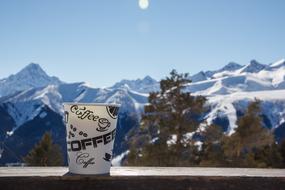 coffee cup on a background of white mountains