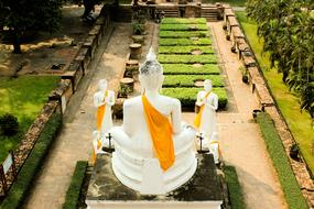 white buddha in the lawn maze