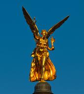 golden angel in the blue sky