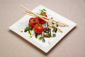 fresh tomatoes with spices on a plate