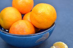 juicy oranges in a blue plate