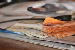 old papers on wooden surface in blurred background