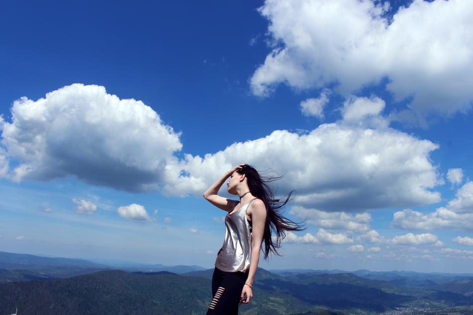 beautiful brunette on a background of white clouds