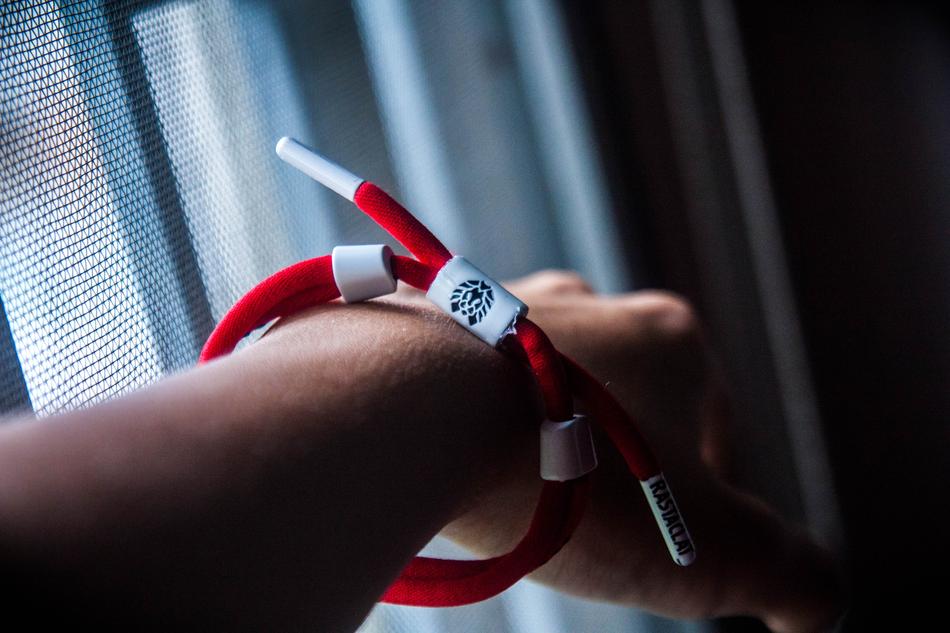 red bracelet on a man's arm