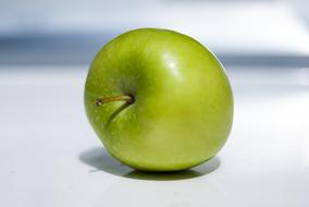 ripe green apple on a white background