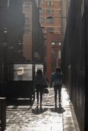 people walk down the lane after the rain