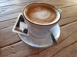 hot cappuccino on a wooden table