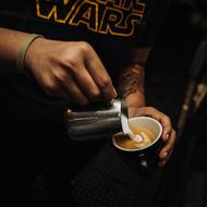 barista making coffee with milk