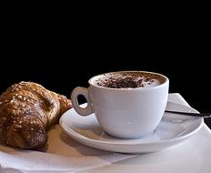 Sesame croissant with a hot drink